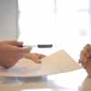 crop businessman giving contract to woman to sign